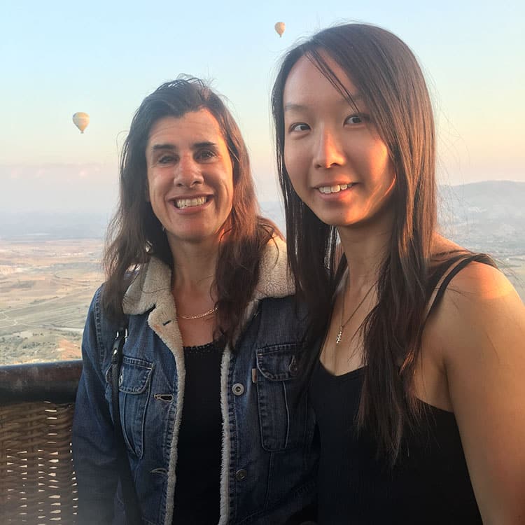 Zel, owner of Inclusive World high in the sky in a hot air balloon with a friend.